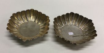 A good pair of shaped silver dishes on pedestal fe