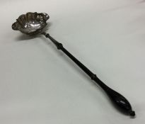 A large Antique silver toddy ladle with turned han