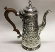 A chased George II silver coffee pot. Approx. 670