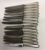 A heavy set of eight (plus eight) silver handled k