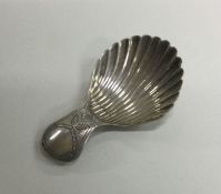 A silver engraved caddy spoon with floral decorati