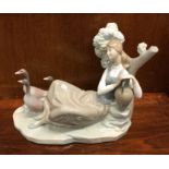 A Lladro figure of a lady. Est. £25 - £30.