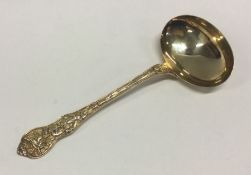 A fine quality silver gilt sauce ladle with chased scene to handle. Approx. 77 grams. Est. £100 - £