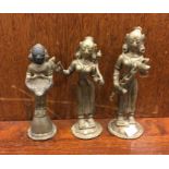 A group of three brass tribal figures. Est. £10 -