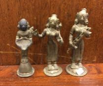 A group of three brass tribal figures. Est. £10 -