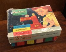A Vulcan Senior child's sewing machine in box. Est