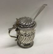 A crested Victorian chased silver mustard pot. London 1888. Approx. 146 grams. Est. £140 - £180.