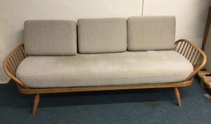 ERCOL: A large three seater day bed. Est. £100 - £