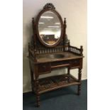 A Continental hardwood dressing table on turned su