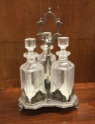 A good silver plated three bottle tantalus. Est. £