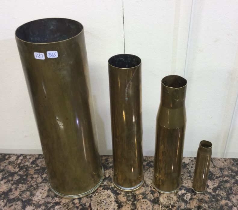 A set of four heavy brass tapering shell cases. Es