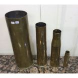 A set of four heavy brass tapering shell cases. Es