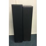 A pair of tall speakers. Est. £25 - £30.