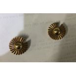 A small pair of gold earrings of floral design. Ap