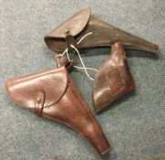 Three leather Military pistol holsters. Est. £20 -