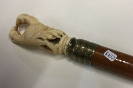 A carved ivory mounted walking stick of tapering f