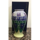 MOORCROFT: A boxed violets baluster vase. Est. £13