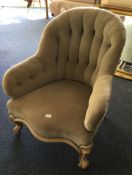 An antique button back arm chair. Est. £40 - £60.