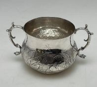 A rare Charles II silver two handled porringer dec