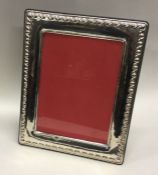 A large and stylish rectangular Continental silver frame. Est. £100 - £120.