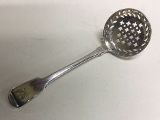 A crested silver sifter spoon. London1817. Approx. 30 grams. Est. £30 - £50.