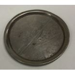 An engraved silver dish depicting a village scene. Approx. 22 grams. Est. £30 - £50.
