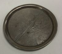 An engraved silver dish depicting a village scene. Approx. 22 grams. Est. £30 - £50.