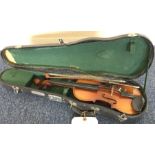 An old cased violin. Est. £20 - £30.