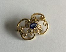 A heavy 18 carat sapphire and diamond brooch of sc