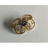 A heavy 18 carat sapphire and diamond brooch of sc