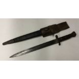 An old bayonet in matching sheath. Est. £20 - £30.