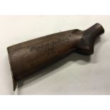 An old wooden rifle butt with Nazi carving. Est. £
