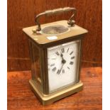 An old carriage clock. Est. £15 - £20.