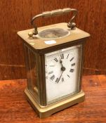 An old carriage clock. Est. £15 - £20.