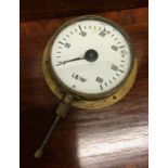 A brass mounted pressure gauge with white enamelle