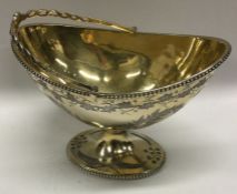 A good Victorian silver gilt engraved swing handled basket. London 1873. By Thomas Smiley. Approx.