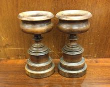 A good pair of turned mahogany urns. Approx. 17 cm