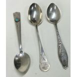 A selection of three various silver spoons, to include one inset with a stone; one of shooting