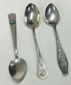 A selection of three various silver spoons, to include one inset with a stone; one of shooting