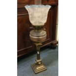 An old oil lamp. Est. £100 - £150.
