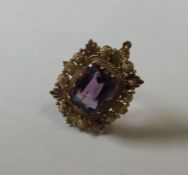 An antique amethyst pendant in two colour gold set