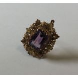 An antique amethyst pendant in two colour gold set
