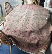 An old rug. Est. £50 - £60.