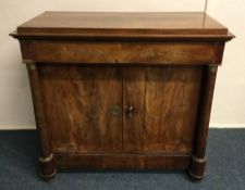 A mahogany two door side cupboard. Est. £50 - £80.