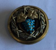 A Victorian 15 carat gold brooch with vine decorat