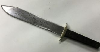 A commemorative Bowie knife engraved with 'Remembe