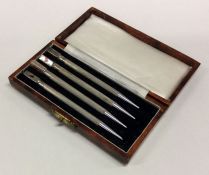 A set of four silver Bridge pencils. Approx. 24 grams. Est. £80 - £120.