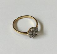 A diamond daisy head cluster ring in 18 carat two