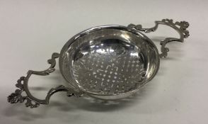 A heavy and rare George III silver two handled lemon strainer. Marked to bowl. Approx. 84 grams.