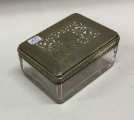 A heavy George III glass dressing table box of square form with pierced silver lid. London 1827.